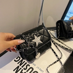 Black quilted mini chain bag with large sparkling rhinestone star and leather-woven strap