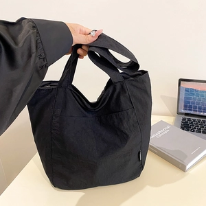 Minimalist black nylon waterproof tote bag with large capacity and wide shoulder strap