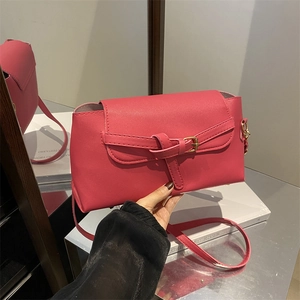 Minimalist rose pink PU leather baguette bag with gold hardware and stylish belt buckle