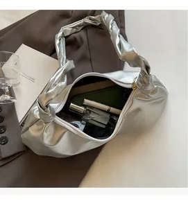 Sac nuage argenté montrant l'intérieur spacieux avec téléphone, parfum et rouge à lèvres
