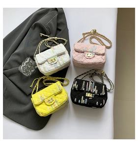Close-up of quilted crossbody bags in four colors with gold metal clasps and chain straps