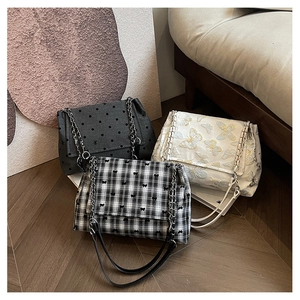 Detailed trio of chain bags in polka dot, butterfly embroidery, and checkered fabric patterns