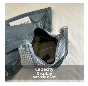 Blue gingham tote bag interior showing daily essentials like umbrella and cosmetics