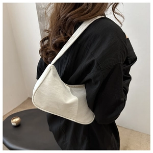 Detailed view of a white nylon hobo bag worn over shoulder with soft pleats