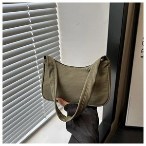 Detail of an olive green nylon baguette bag showing minimalist texture and sleek design