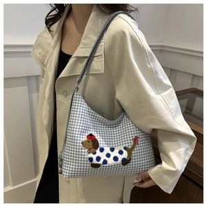 Detail of blue gingham shoulder bag with a cute 3D dachshund dog embroidery appliqué