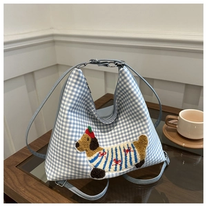 Detail of blue gingham hobo bag featuring a chenille dachshund patch and dual straps