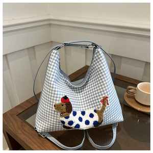 Detailed view of blue plaid canvas tote featuring a cute 3D chenille embroidered dog