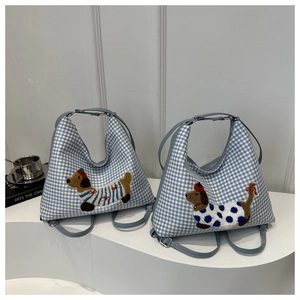 Detail of blue gingham tote bag with cute dachshund embroidery and top zipper closure