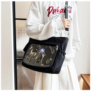 Detail of black crossbody ita bag with a large transparent display window and wide strap