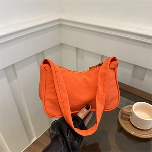 Minimalist orange nylon crescent bag with wide strap for casual autumn shoulder wear