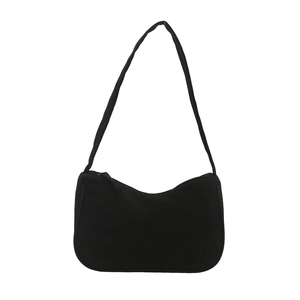 Minimalist black crescent shoulder bag with canvas texture and sleek zipper closure