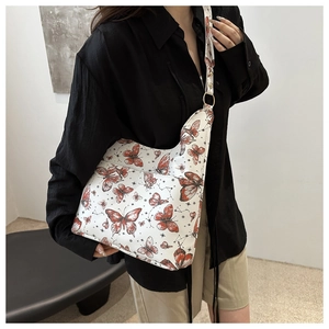 Detailed shoulder view of a vintage butterfly print tote bag with stylish wide straps