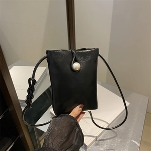 Black leather mini crossbody phone bag featuring a large pearl clasp and braided strap