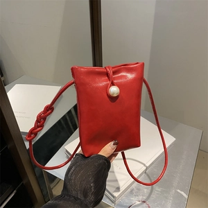 Chic red glossy mini shoulder bag with large pearl buckle and woven knot strap details