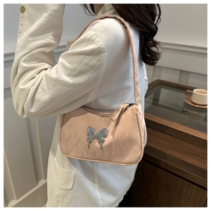 Detail of light pink shoulder bag with liquid silver butterfly metal hardware