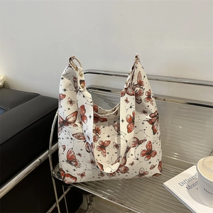 Minimalist white tote bag with red butterfly print and wide shoulder strap for women