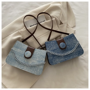 Detail of denim and tweed flap bags with metallic chains and silver glitter texture