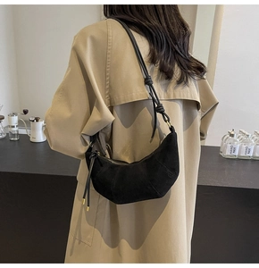 Black suede croissant bag styled with a khaki trench coat for a casual back-view look