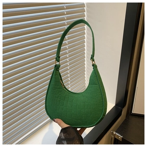 Detail of green crocodile embossed texture on a large capacity minimalist felt tote bag