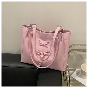Pink PU leather tote bag featuring lace-up corset detail and silver ring handle attachment