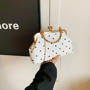 Chic white polka dot crossbody bag with gold metal clasp and chain strap for women