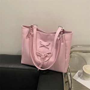 Pink soft leather tote bag with corset-style lace design and silver metal ring handles