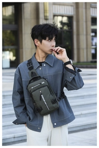 Detail of olive green waterproof chest bag featuring adjustable buckle and nylon fabric texture