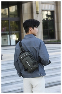 Detailed view of durable green tactical chest bag with adjustable strap and buckles