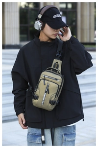 Detail of khaki green multi-pocket waterproof nylon chest bag on male model outdoors