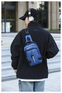 Blue waterproof chest bag with dual zippers and adjustable straps worn by a male model