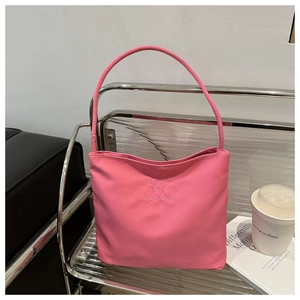 Detail of pink nylon shoulder bag with letter embroidery and round top handle