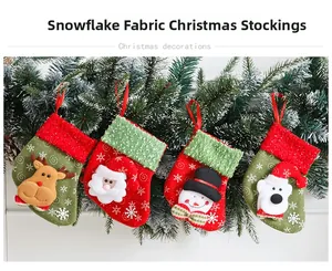 Set of 4 Christmas stockings with reindeer, Santa, and snowman hanging on green pine branch