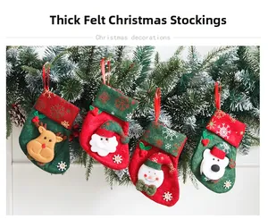Detailed view of four felt Christmas stockings with Santa, reindeer, and snowman designs