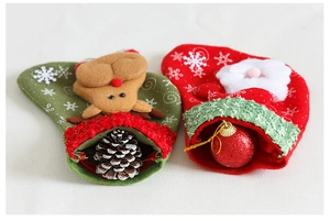 Detail of Christmas stocking bags with plush Reindeer and Santa Claus snowflake motifs