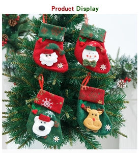 Detail of four Christmas stockings with Santa, Snowman, Bear, and Reindeer hanging ornaments