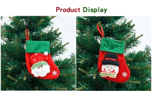 Detailed view of Santa and Snowman felt Christmas stockings with sequins on a tree