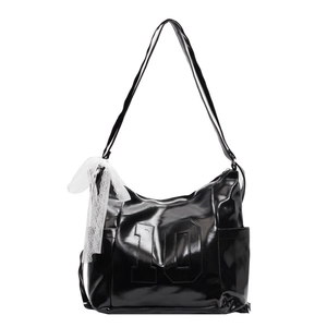Chic black glossy tote bag with number 10 embossing and a delicate white lace bow