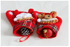 Detail of plush Christmas stockings with elf and bear characters on rustic cloth