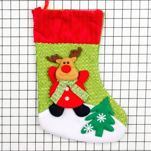 Christmas stocking with reindeer and tree appliqué in red and green for tree hanging
