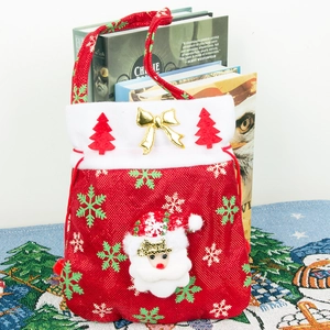 Christmas Santa gift bag with plush trim and gold bow, festive red candy tote handle bag