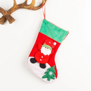 Corduroy Christmas stocking with Santa and tree decor hanging on a wooden antler branch