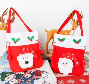 Detail of red velvet Christmas bags with Santa and polar bear 3D plush characters