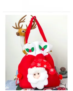 Detail of red velvet Christmas gift bag with Santa Claus embroidery and drawstring closure