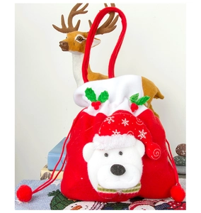 Detail of red Christmas gift bag with 3D polar bear and festive drawstring closure