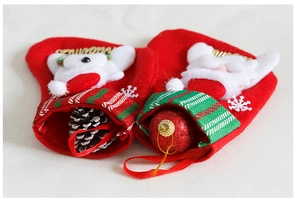 Close-up of red Christmas socks with plush cartoon characters and golden embroidery detail