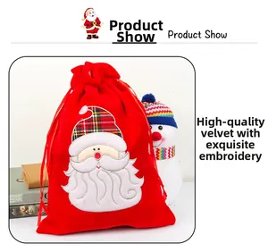 Detail of red velvet Christmas gift bag with Santa Claus embroidery and drawstring closure
