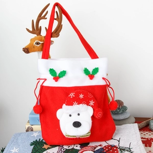 Red velvet Christmas gift bag with polar bear design and drawstring pompom closure