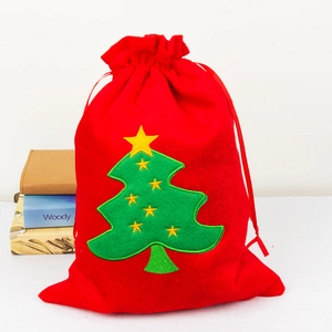 Red velvet Christmas gift bag with green tree embroidery and drawstring closure