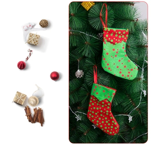 Close-up of red and green polka dot Christmas stocking ornaments hanging on a decorated tree